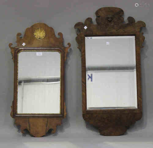 A 20th century George III style walnut wall mirror with a fretwork frame and gilded shell motif,