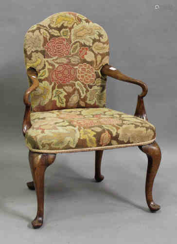 An early 20th century George I style walnut shepherd's crook elbow chair, upholstered in floral