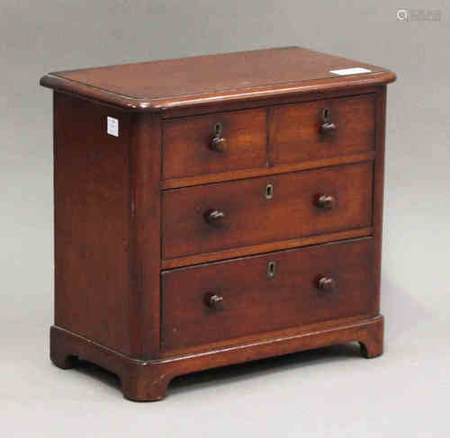 A mid-Victorian mahogany diminutive table-top chest of three long drawers, on bracket feet, height