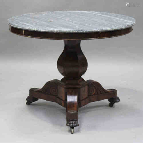 A French Empire mahogany and grey marble topped circular centre table, raised on a baluster