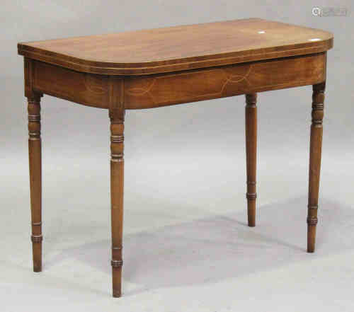 A George IV mahogany fold-over tea table, the frieze with boxwood line inlaid borders, raised on