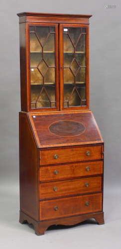An Edwardian mahogany and satinwood crossbanded narrow bureau bookcase, the moulded pediment above a