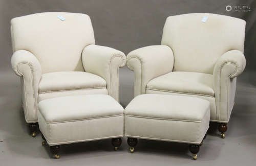A pair of George V Howard style scroll armchairs, upholstered in cream fabric, raised on turned feet