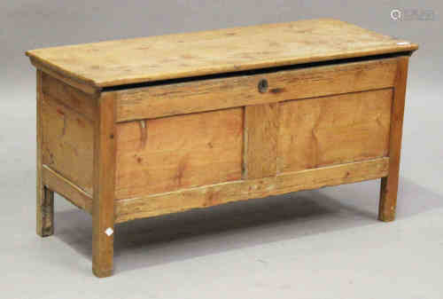 A 17th century stripped pine coffer, the hinged lid above a double panel front, on stile supports,