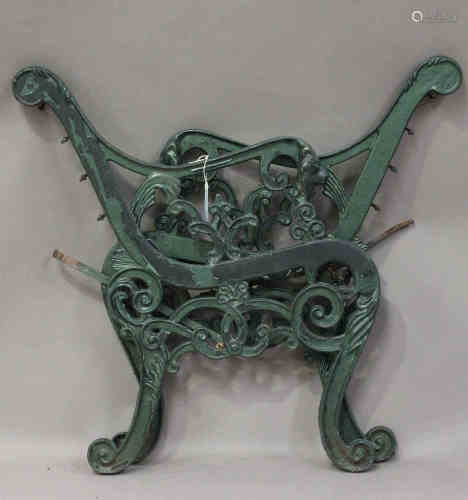 A pair of 20th century cast iron garden bench ends, the foliate scrolling frames with lion mask