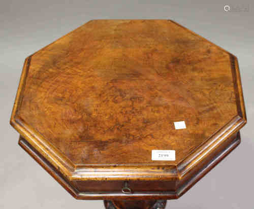 A Victorian walnut octagonal work table, the hinged lid above carved cabriole legs, height 71cm,