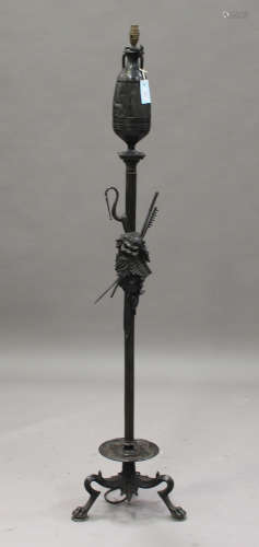 A 19th century green patinated cast bronze Estruscan style standard lamp, the urn-shaped top above a