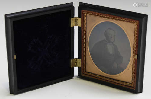 A late Victorian ambrotype depicting a seated gentleman, within a moulded bois durci case, height
