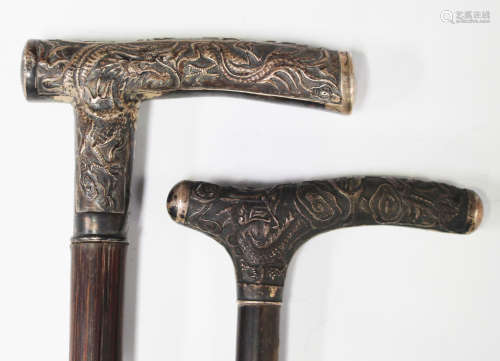 An early 20th century walking stick with a Chinese white metal handle, decorated with figures,