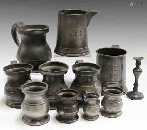 A collection of mainly 19th century pewter tankards and measures, including a pint tankard inscribed