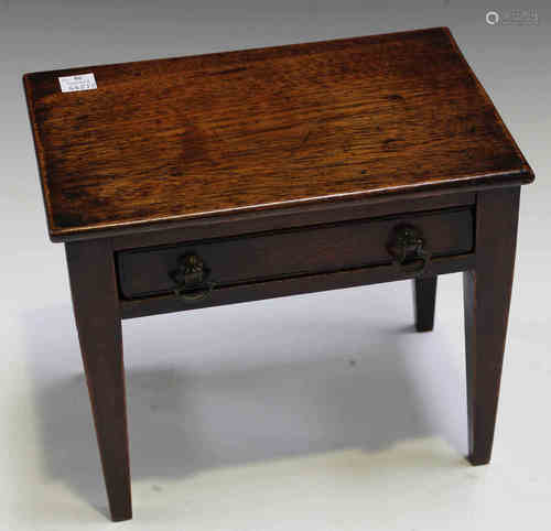 A 19th century mahogany diminutive model of a side table, fitted with a single drawer, on tapering