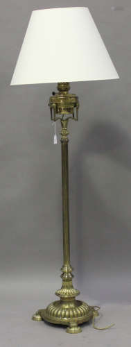 An early 20th century brass telescopic oil lamp standard, the reeded stem on a domed circular base