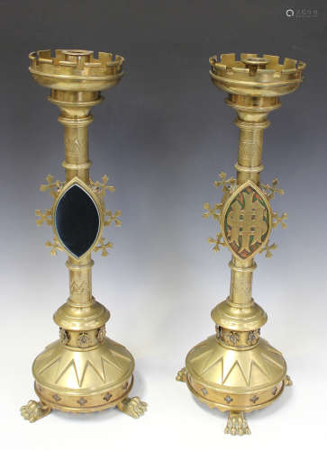 A pair of late 19th/early 20th century Gothic Revival ecclesiastical brass candlesticks, the