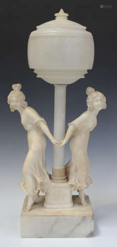 An early 20th century carved white marble and alabaster figural table lamp, the circular shade and