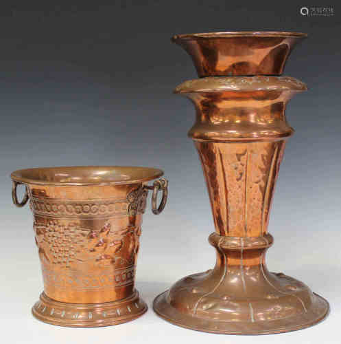 An Arts and Crafts style copper wine cooler, the tapering body worked with grapes and vine leaves,