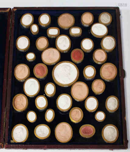 A group of 19th century moulded plaster portrait intaglios, mounted within a burgundy leather