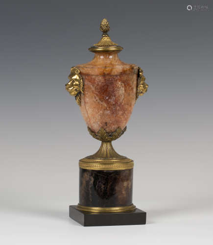 A 19th century Blue John and gilt bronze mounted ornamental urn, the pineapple and stiff leaf finial