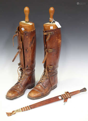 A pair of brown leather riding boots, fitted with wooden lasts by Peal & Co, London, together with a