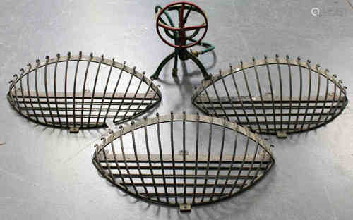 A set of three 20th century wrought iron wall mounted hay racks, width 80cm, together with an