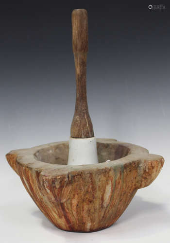 An early 20th century carved marble and wooden handled pestle and mortar, the exterior of the mortar