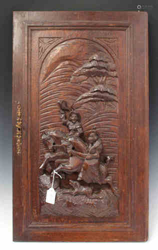 A late 19th/early 20th century French oak door, carved in high relief with two figures on horseback,