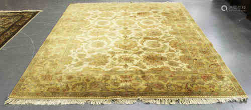 An Indian carpet, late 20th century, the ivory field with overall palmettes and scrolling vines,