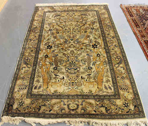 A Kashmir pictorial prayer rug, mid-20th century, the ivory mihrab with a flower-filled urn