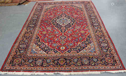 A Kashan carpet, Central Persia, mid-20th century, the red field with a shaped medallion,