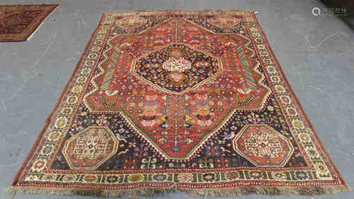 A Shiraz carpet, South-west Persia, mid-20th century, the red field with a shaped medallion,