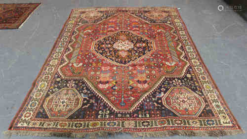 A Shiraz carpet, South-west Persia, mid-20th century, the red field with a shaped medallion,