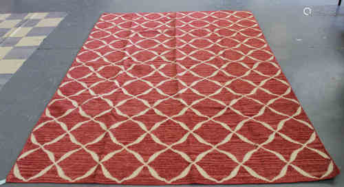 A modern flatweave carpet with an overall design of a red square lattice, 294cm x 201cm.Buyer’s