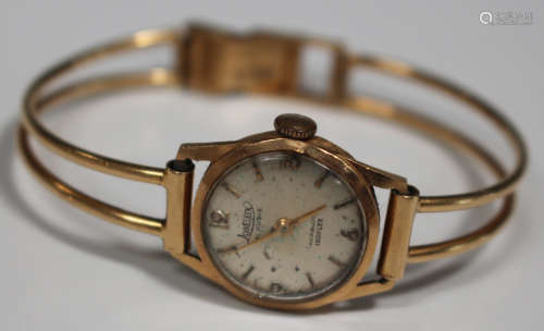 A Loreleix Isoflex gold cased lady's wristwatch, the case back detailed '18K 0,750', on a curved bar