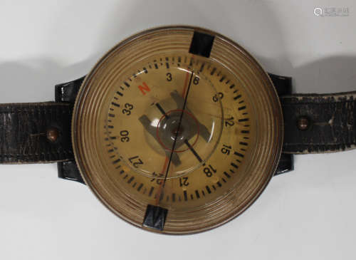 A German AK39 pilot's wrist compass, the circular case with clear plastic dial, the case back