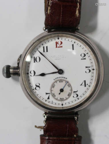 A Longines silver circular cased gentleman's wristwatch with a signed jewelled movement, the