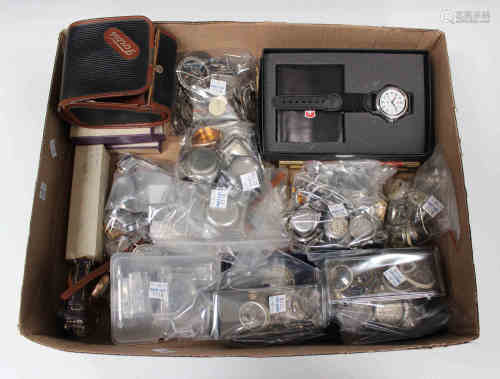 A collection of mostly stainless steel wristwatch cases and other watch parts, including bezels