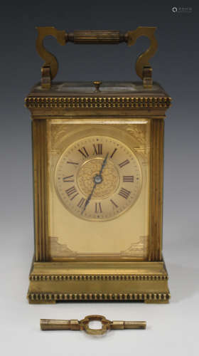 A late 19th/early 20th century lacquered brass carriage clock with eight day movement repeating
