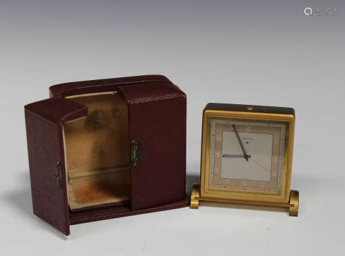 A Zenith gilt brass cased bedside alarm clock with eight day movement, the signed silvered dial with