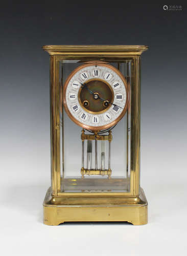 A late 19th/early 20th century lacquered brass four glass mantel clock with eight day movement