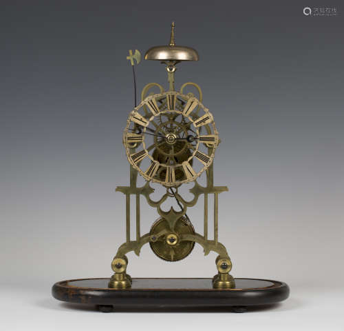 A late Victorian brass skeleton clock with single fusee movement striking hours on a bell, the