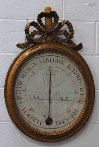 A 19th century French giltwood framed oval wall barometer with central alcohol thermometer, the