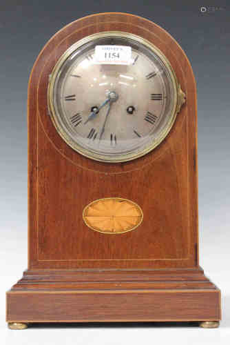 An Edwardian mahogany mantel clock with French eight day movement striking on a gong, the silvered