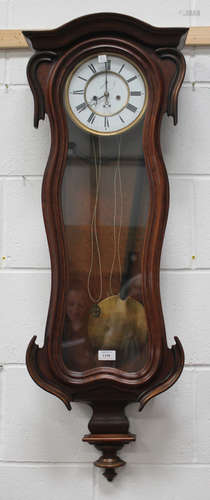 A late 19th century walnut cased Vienna style wall clock with eight day movement striking on a gong,