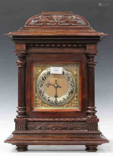 An early 20th century German stained beech mantel clock with eight day movement chiming and striking