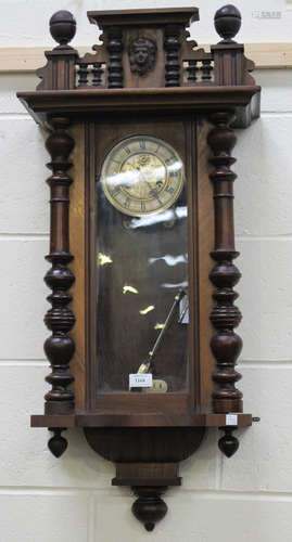 A late 19th/early 20th century walnut cased Vienna style wall clock with eight day movement striking