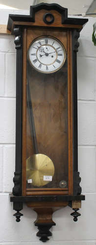 A late 19th century walnut and ebonized cased Vienna style wall clock with eight day movement