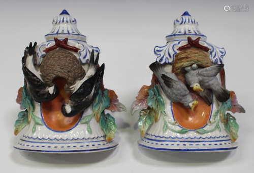 A pair of French porcelain wall pockets, late 19th century, both modelled with different bisque