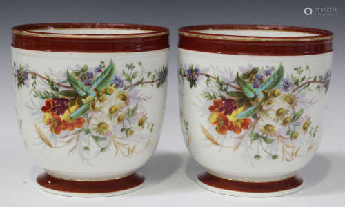 A pair of French porcelain cachepots, late 19th century, of typical U-shape, painted with flowers