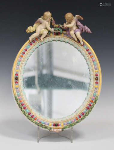 A Meissen porcelain oval mirror frame, late 19th century, moulded with polychrome enamelled oval
