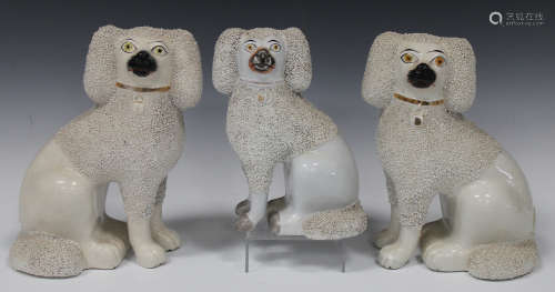 A pair of Staffordshire pottery poodles, late 19th century, with shredded clay fur detail, height
