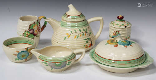 A mixed group of Art Deco tablewares, mostly Wilkinson, with some Clarice Cliff shapes and patterns,